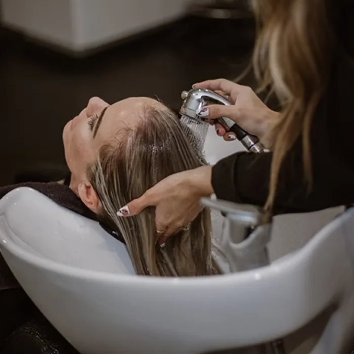 Woman getting hair washed