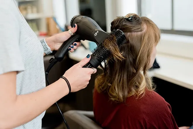 Woman getting hair curled